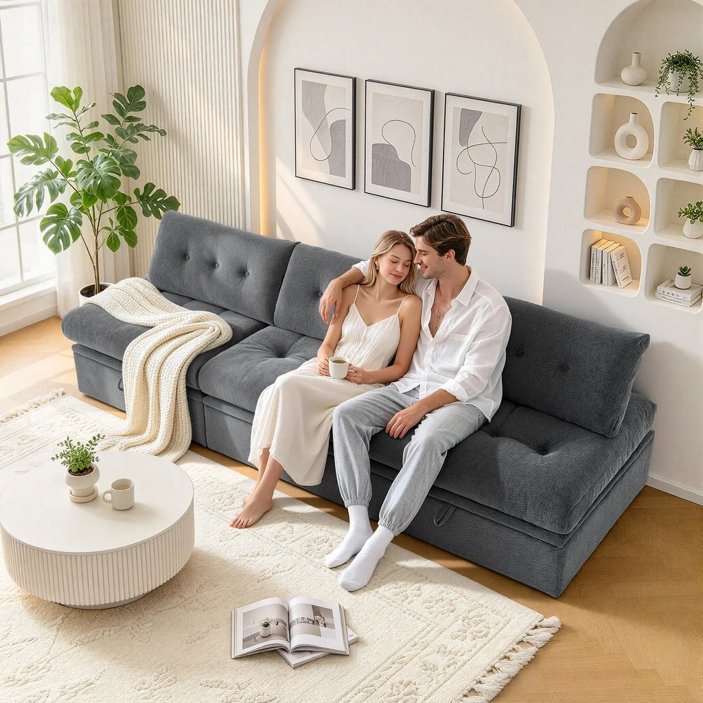 Side level view of a couple sitting on a Korser gray  3-seater straight modular storage sofa with backrests enjoying a cozy moment in a modern living room.